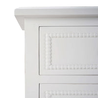 Close-up of bead detailing on white chest.
