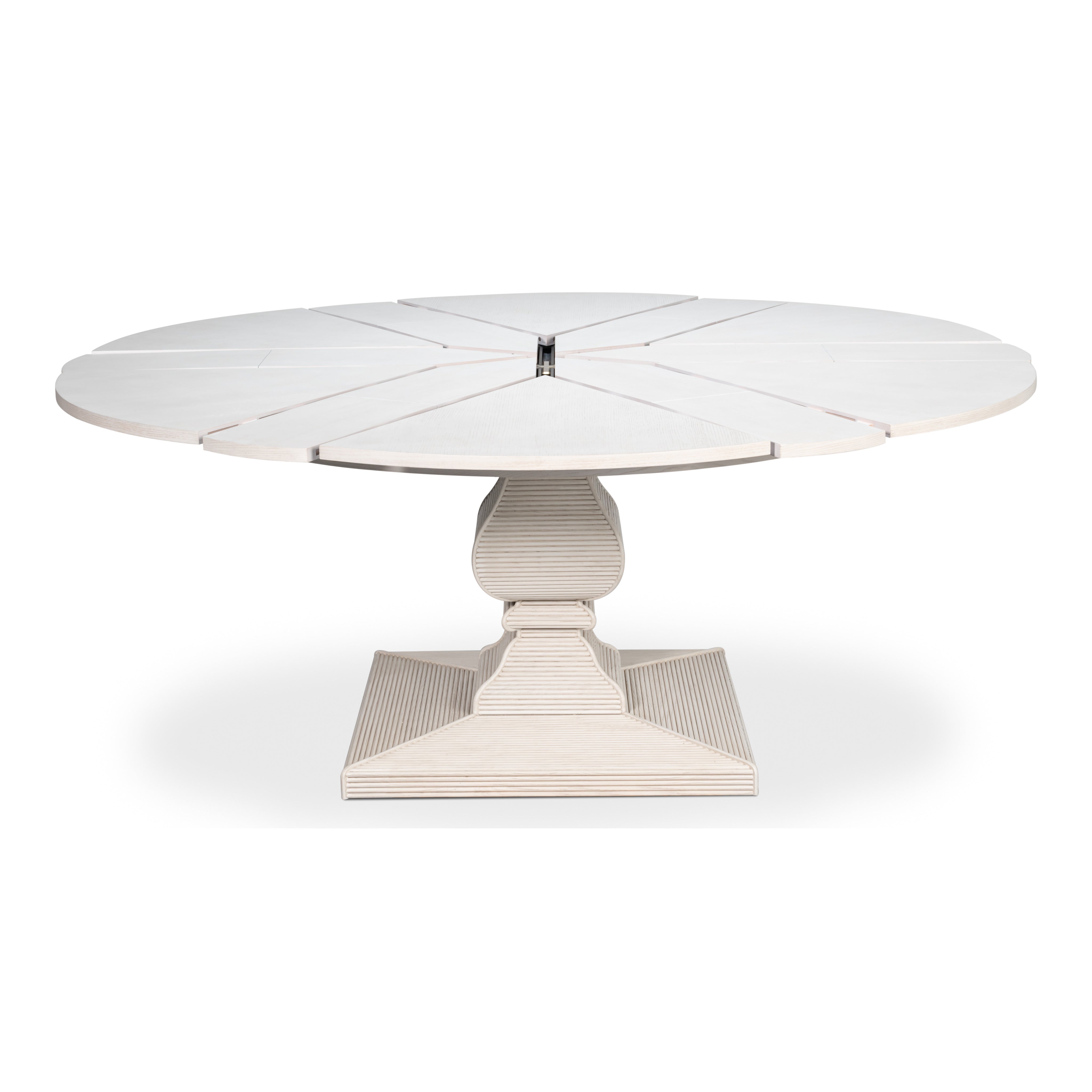 Round white extending dining table with reeded pedestal base