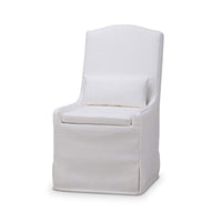 White slipcovered dining chair, angled front view.