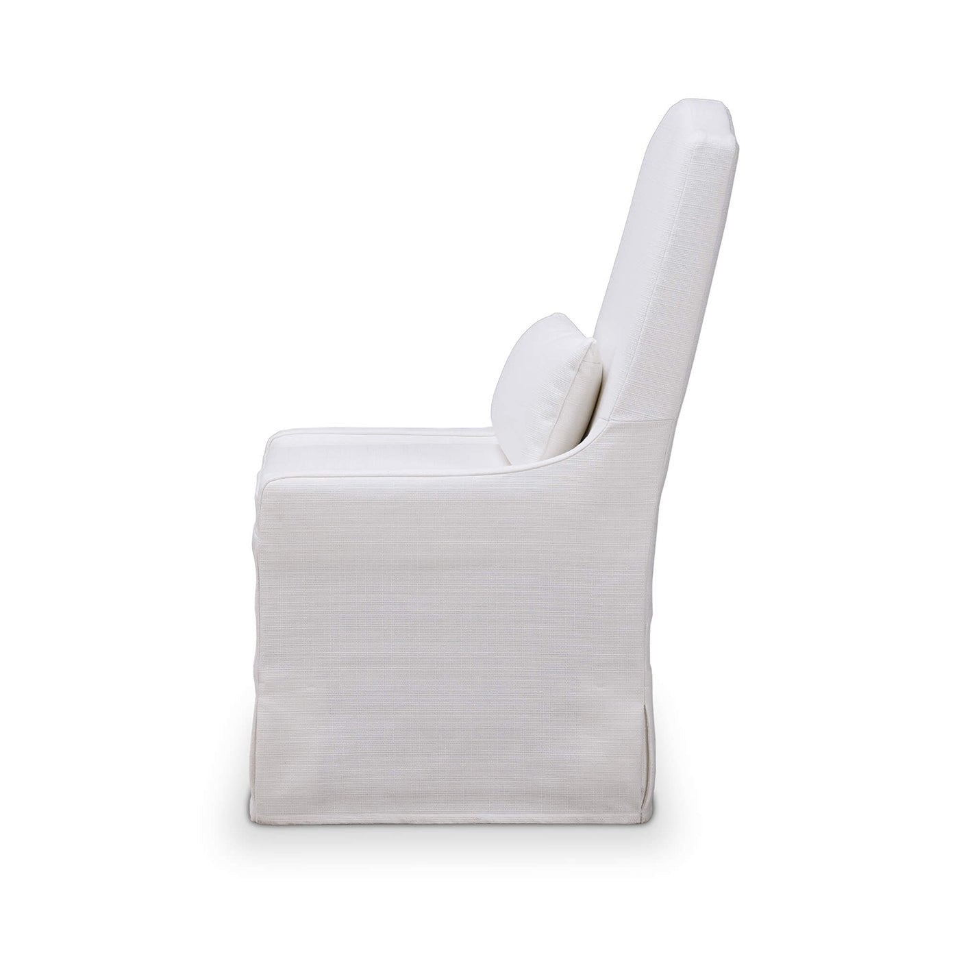 White slipcovered dining chair, side profile view.