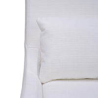 Close-up of chair with cushion, white slipcover.