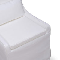 Seat area detail of white slipcovered dining chair.