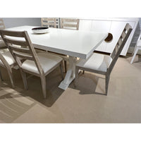 Close-up of dining table with chairs, top detail.