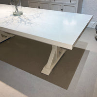 Corner view of dining table, sleek smooth surface.