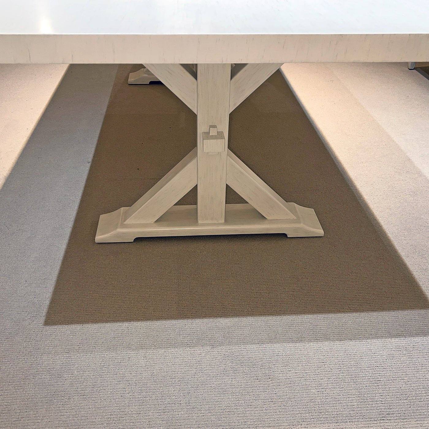Under-table view, focus on trestle base design.
