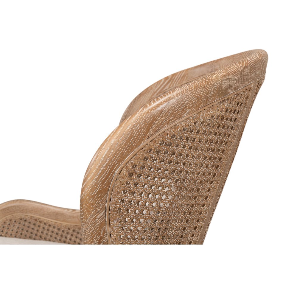 Side detail of woven back and wood of armchair.