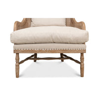 Close-up of armchair front legs and cushion.