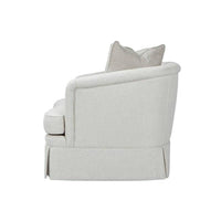 Beige art deco armchair, side profile with pillows.