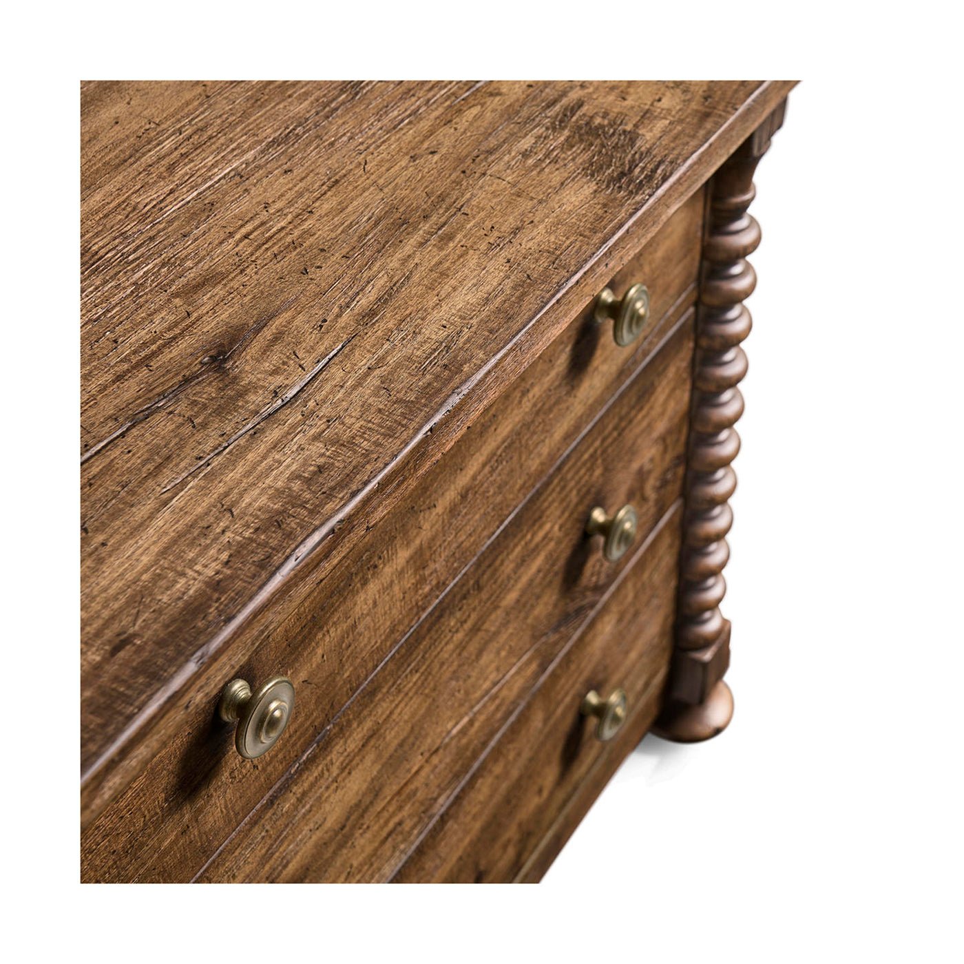 Close-up of drawer front on nightstand, metal knobs visible.