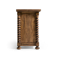 Side view of nightstand, showcasing turned wooden legs.