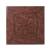 Detailed top view of antique end table with pattern.