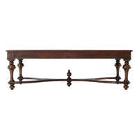 Side profile of wooden coffee table showing intricate legs.