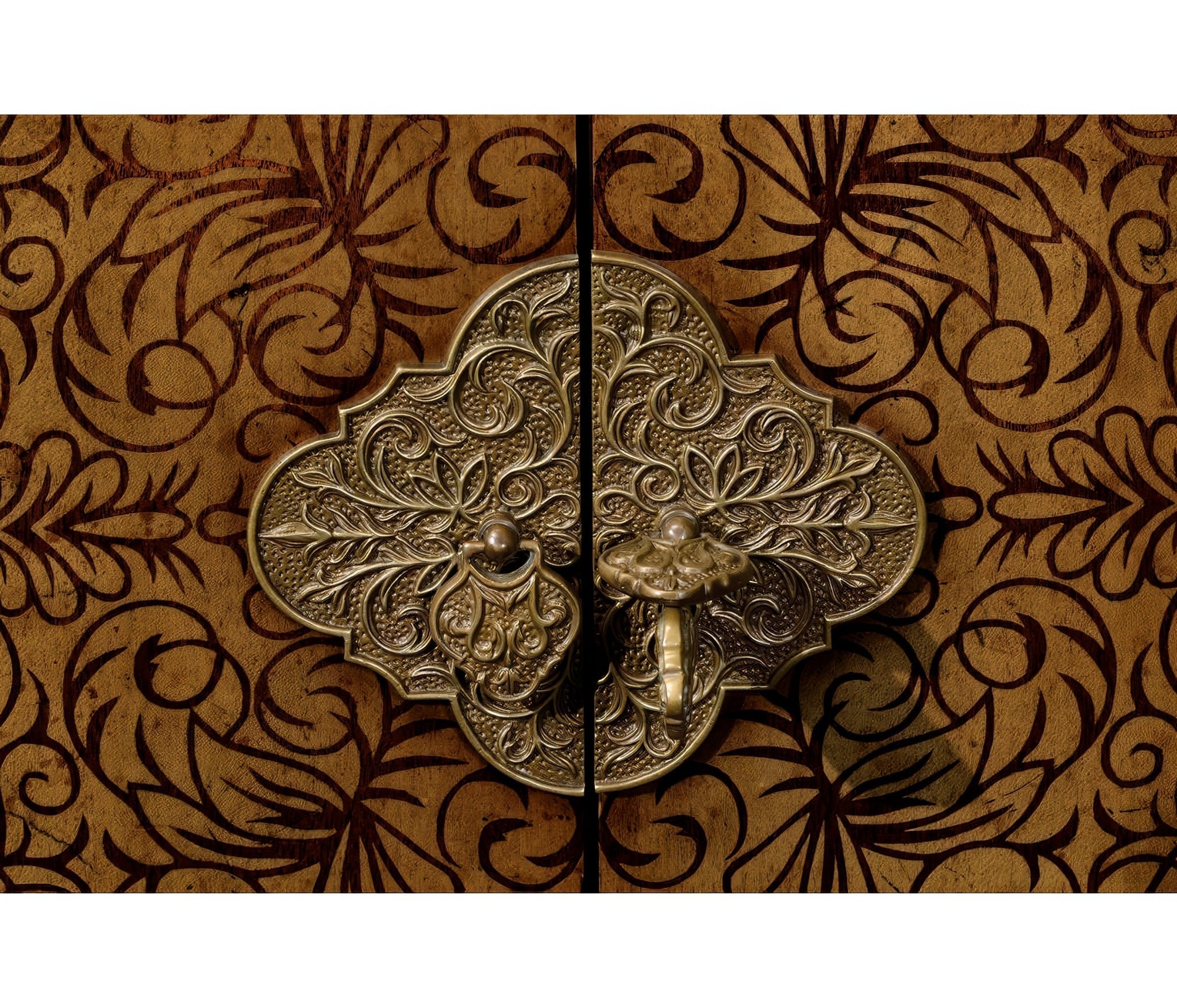 Close-up of ornate metal cabinet latch detail.