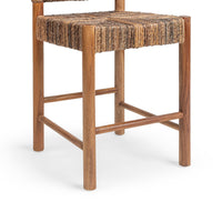 Close-up of the brown abaca seat, teak legs and built-in wood footrest