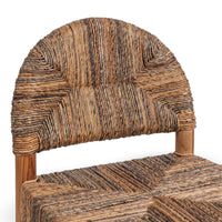 Detail of the arched brown abaca backrest and the varied tones of its woven seat