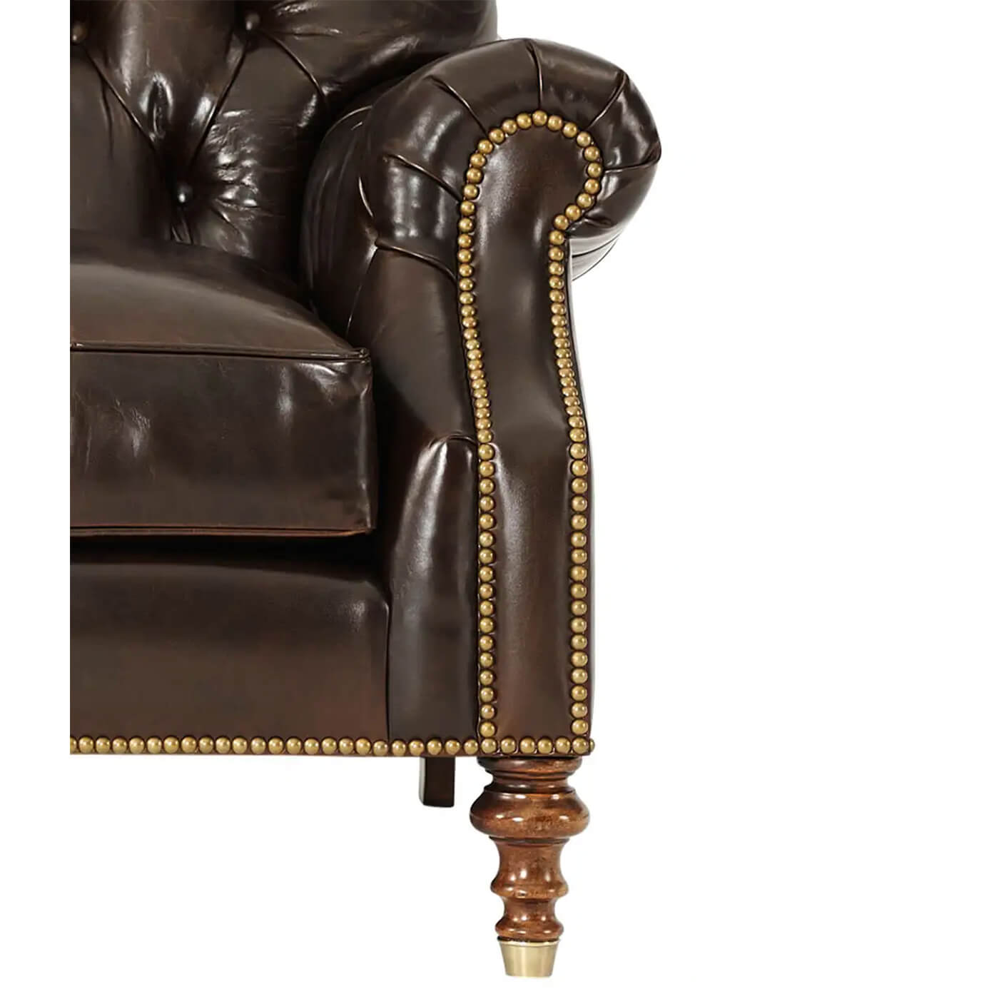 Close-up armrest of leather club chair, nailhead detail.