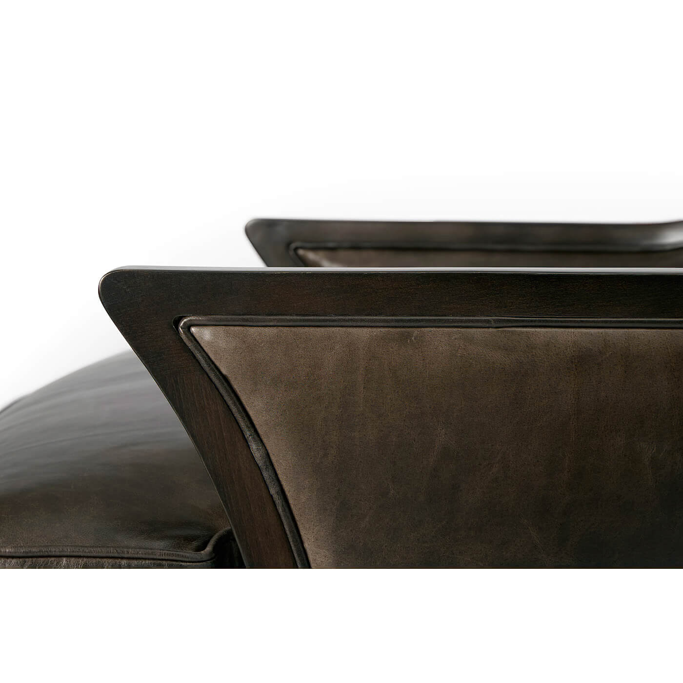 Modern upholstered wingback chair, close-up of arm detail.