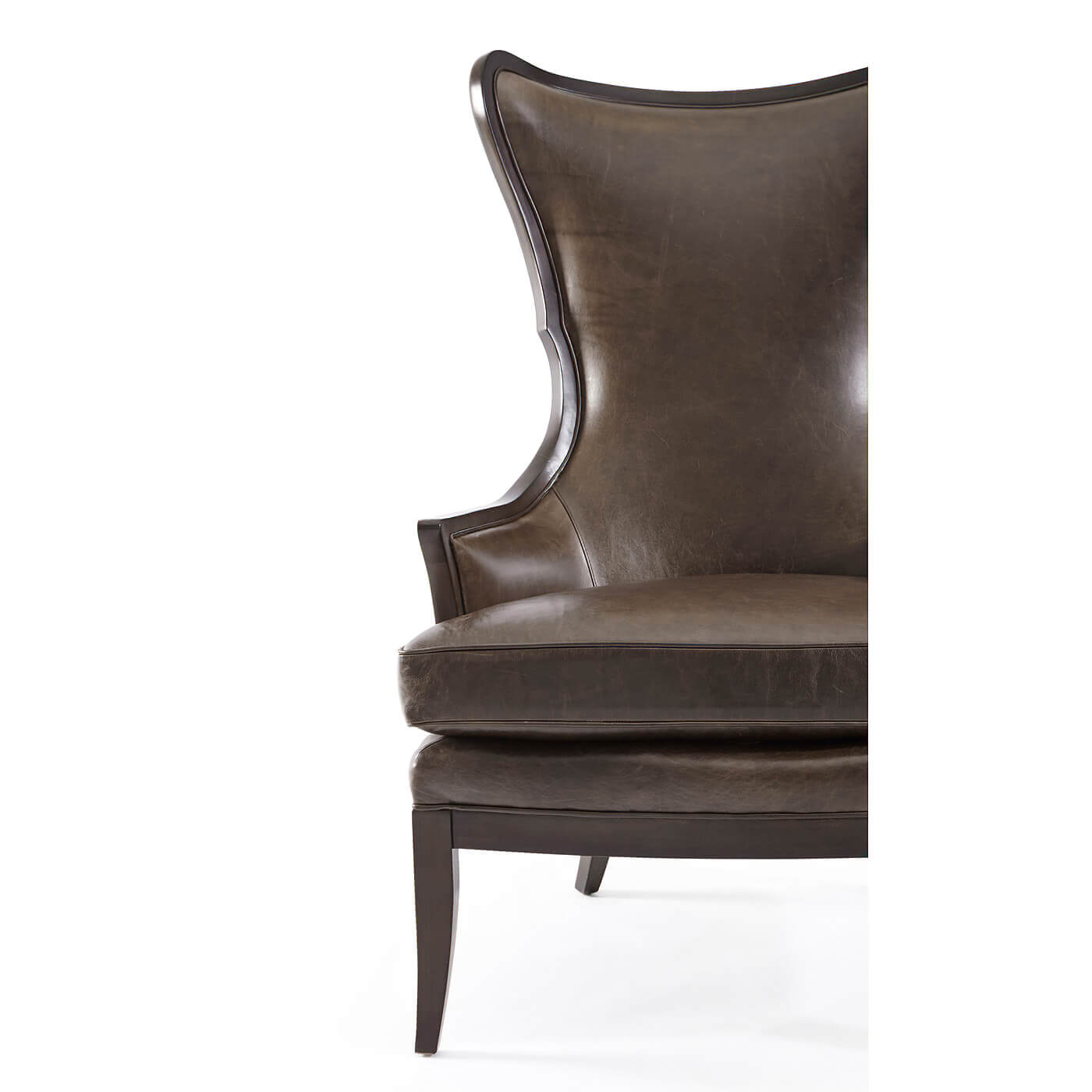 Modern upholstered wingback chair, partial front view.
