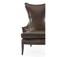 Modern upholstered wingback chair, partial front view.