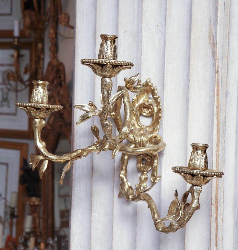 Side view of intricately designed bronze sconce.