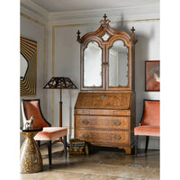 Walnut secretary bookcase styled in elegant living room.