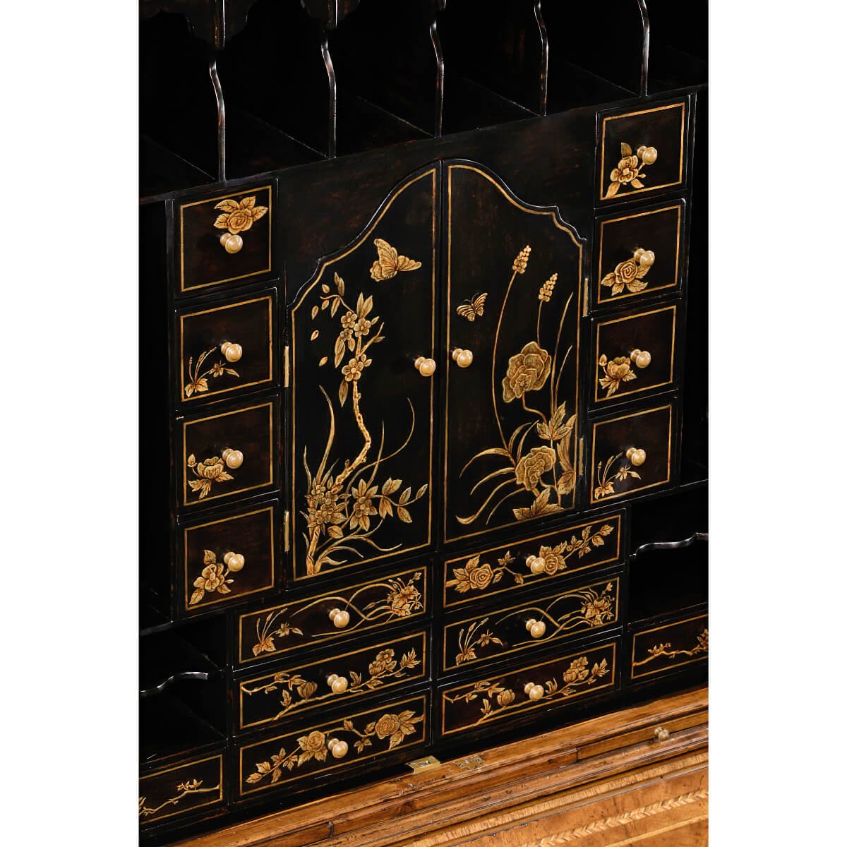Detailed chinoiserie design on secretary desk interior.