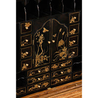 Detailed chinoiserie design on secretary desk interior.